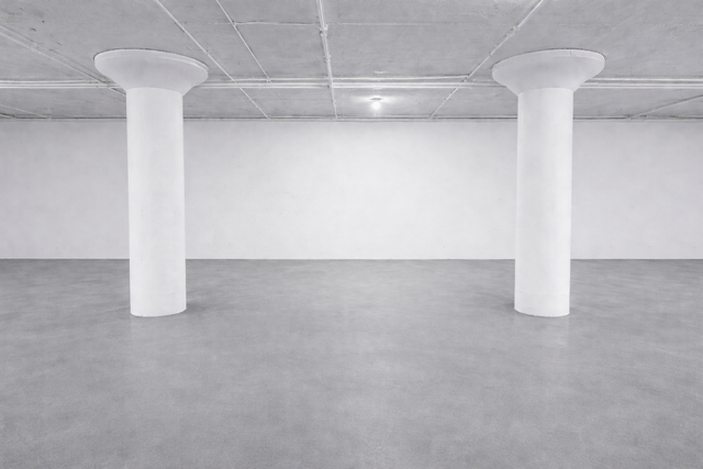 Indoor storage bay with white columns and polished concrete floor
